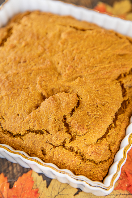 Pumpkin Cornbread - a delicious twist to regular cornbread. Even pumpkin haters LOVE this cornbread. Super easy to make and tastes great. Flour, baking powder, salt, pumpkin pie spice, pumpkin puree, oil, and molasses. Serve with a big dollop of honey butter! Great for Thanksgiving dinner or as a side to your favorite soups and stews. #pumpkin #bread #cornbread pumpkin cornbread in baking dish