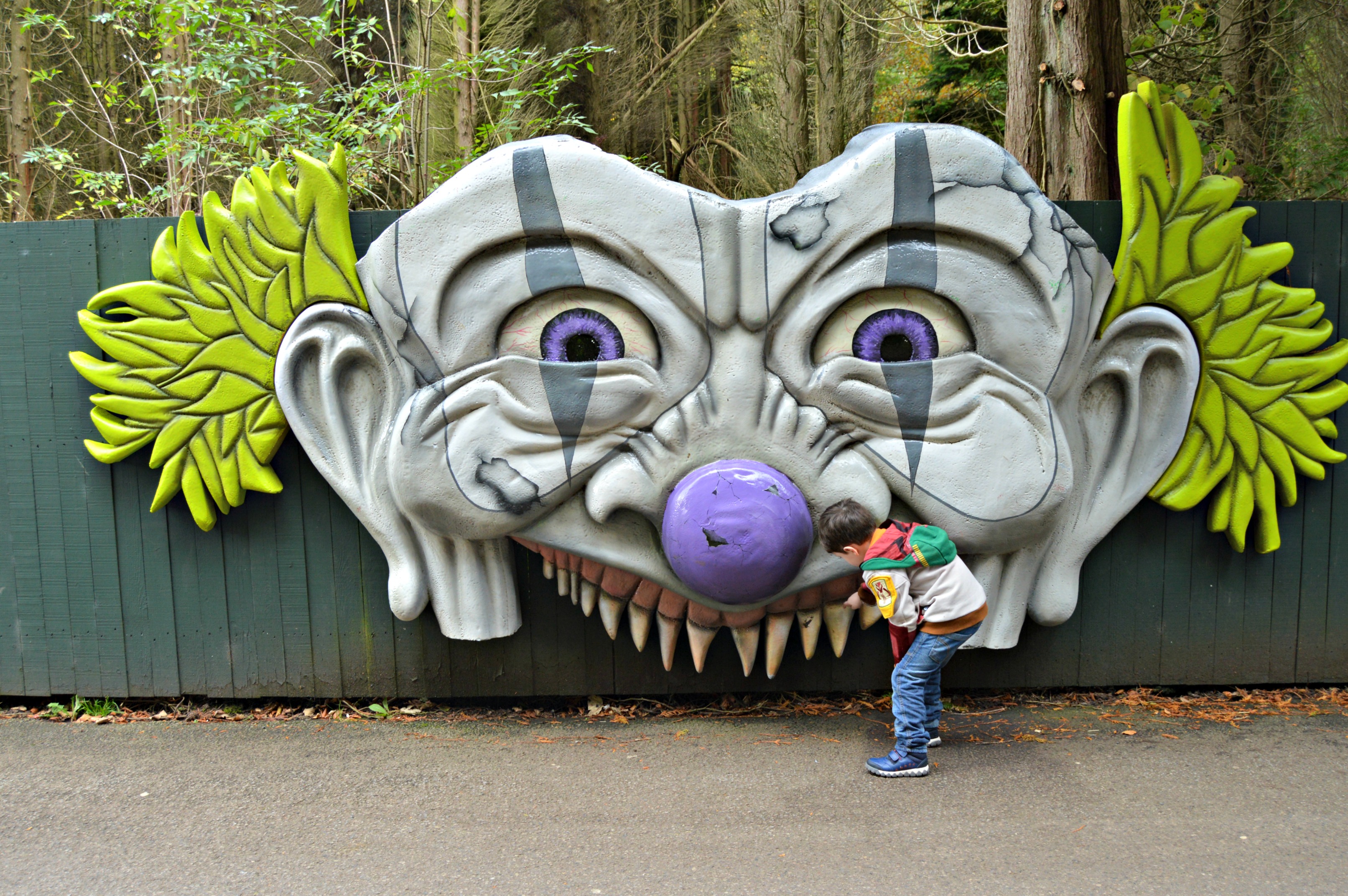 boy looking in to a clowns mouth