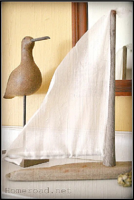 driftwood sailboat and bird on mantel