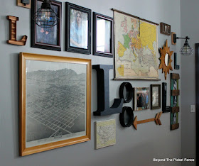 use old maps and photos and other vintage items to create a gallery wall