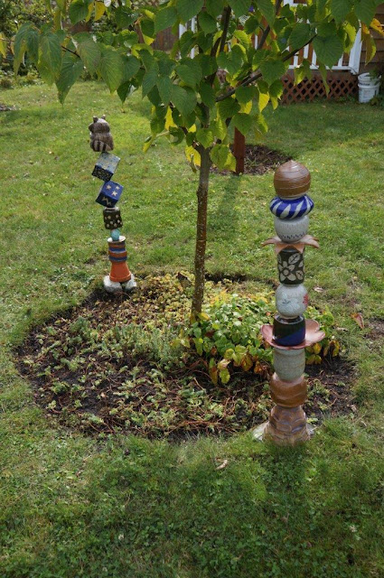 Davidii involucrata (dove) tree with handmade ceramic totems and succulent underplanting.