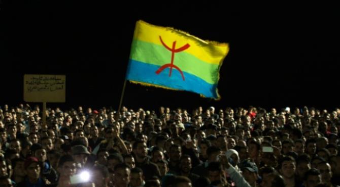 Protesters hold the Amazigh (Berber) flag during a demonstration in the northern Moroccan city of Al Hoceima on October 30, 2016, following the death of fish seller Mouhcine Fikri. By Fadel Senna