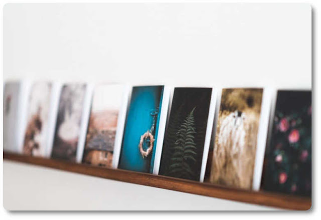 Picture frame ledge shelf holding photo of the same size Floating picture shelf
