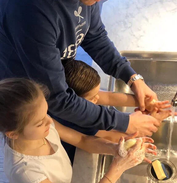 Princess Estelle and Prince Oscar are seen carefully washing their hands. Crown Princess Victoria and Prince Daniel