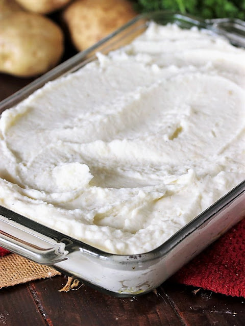 Mashed Potatoes Spooned Into Baking Dish Image