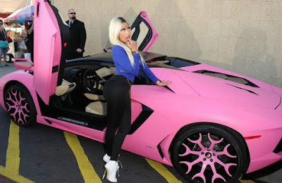Kenneth Petty's wife Nicki posing with her car
