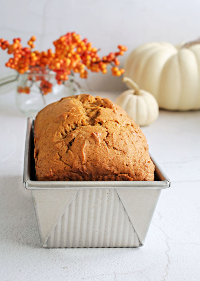 Recipe for a fluffy, flavorful pumpkin loaf cake topped with salted caramel cream cheese frosting.