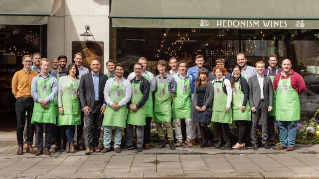 Team members at Hedonism wines in Amore Beaute aprons