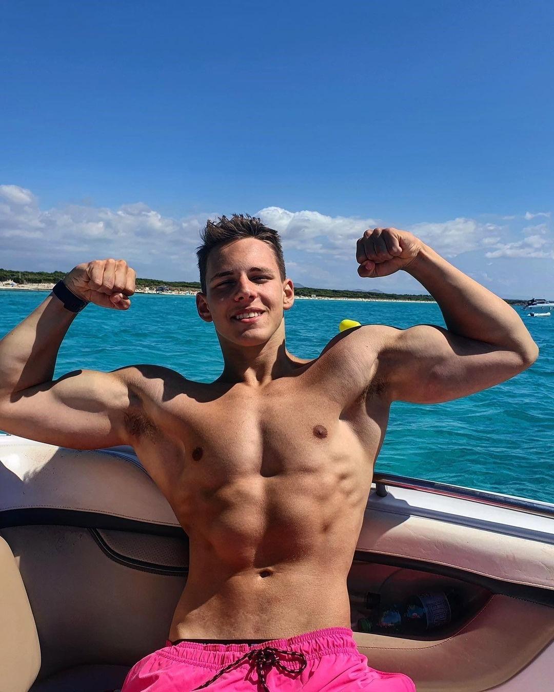 cute-fit-shirtless-eastern-european-boy-biceps-flex-smiling-summer-sea-vacation-pictures