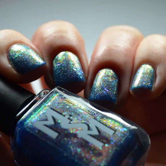 blue shimmer nail polish with flakies swatch