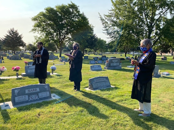 Buddhist ministers chanting at cemetery