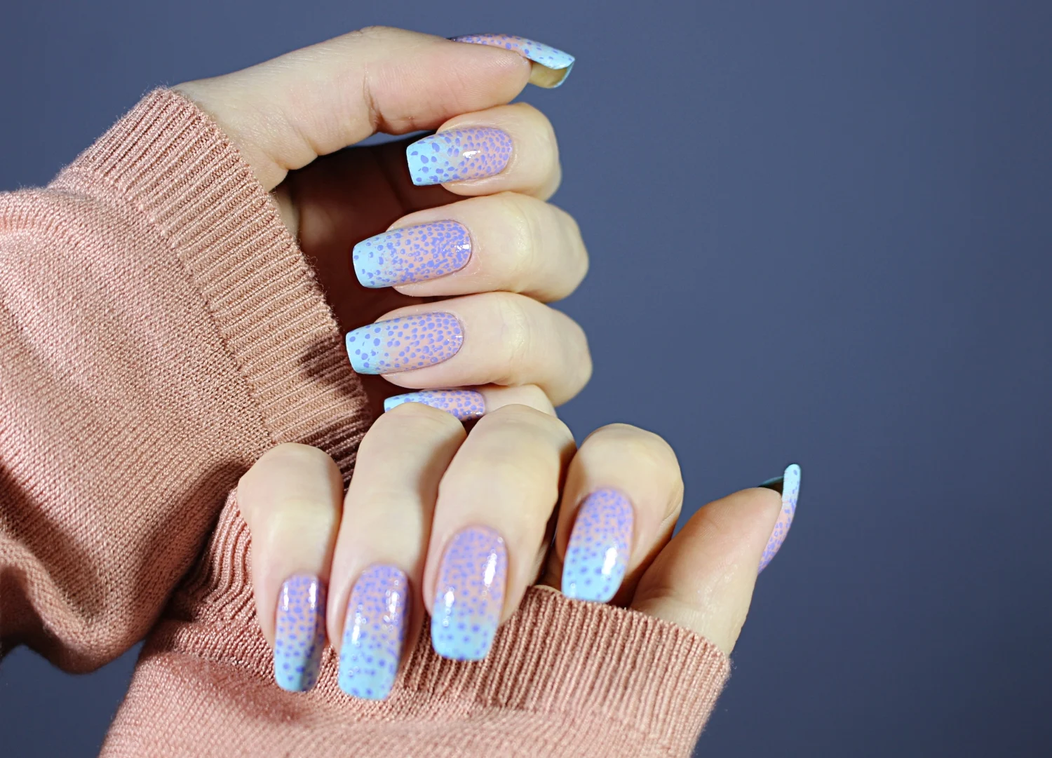close-up of natural, long nails with pastel ombre nail look inspired by unicorns tears