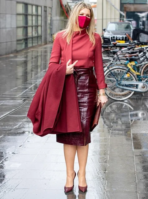 Queen Maxima wore a red wool coat from Natan, and burgundy leather skirt and silk blouse from Natan