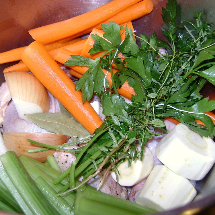 Chicken and veggies and herbs in pot ready to make Chicken Soup with Mini Matzo Balls by Renee's Kitchen Adventures