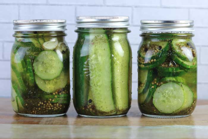 How to make easy refrigerator dill pickles. These tangy pickles are ready overnight! Use spears or sliced chips for a small batch recipe.  This DIY recipe is crunchy, crispy, and has a dill and garlic flavor. Make the best homemade quick with fresh cucumbers and dill. Make one jar or several with this easy recipe. #pickles #fridge #refrigerator #dill
