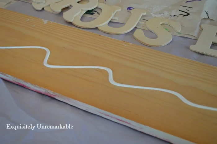 Paint a board for a wooden sign