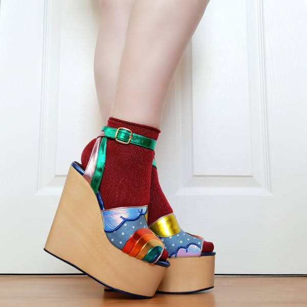 wearing glitter ankle socks and rainbow themed wedge shoes