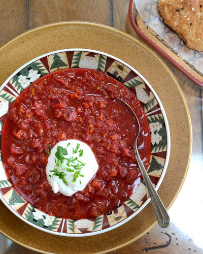 Karelian Borscht (Russian Beet Borscht Soup) ♥ KitchenParade.com, extra hearty with sausage and a swirl of sour cream but also especially earthy and delicious as a vegetarian borscht.