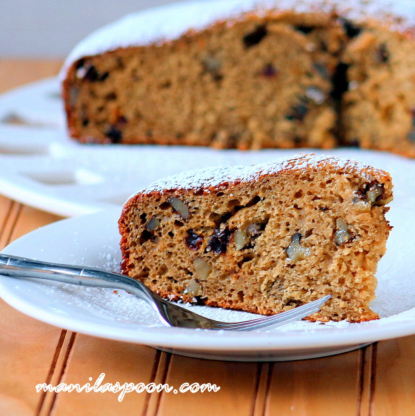 No oil or butter is used in this cake yet it comes out so moist and tasty! Perfectly spiced with cinnamon and nutmeg with added fruity goodness from raisins and crunch from walnuts, it's the perfect cake for coffee or tea time! #applesauce #cake #sweets #desserts #lowfat #nobutter