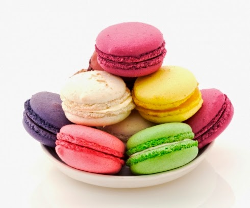 pink, lime, raspberry and vanilla macaroons on a white plate