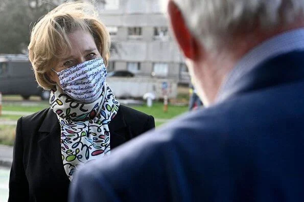 Princess Delphine of Belgium wore a black belted blazer and silk satin print scarf from Saxe-Coburg. Professor Tessa Kerre is president of the fund