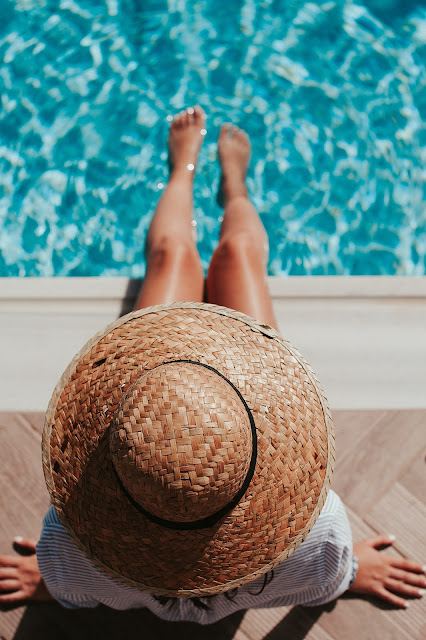 woman dangling her feet into a swimmng pool - Typecast :2021 Summer Clothing Trends For Women