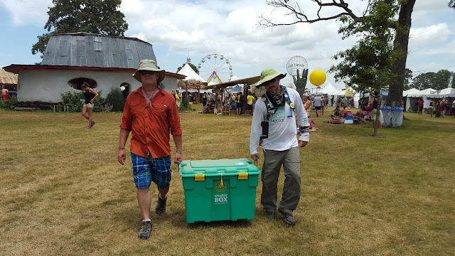 Ron and Chris carry a ShelterBox through Bonnaroo