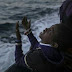 Photo of an African child crying while celebrating his arrival to Europe after being rescued from the Mediterranean Sea