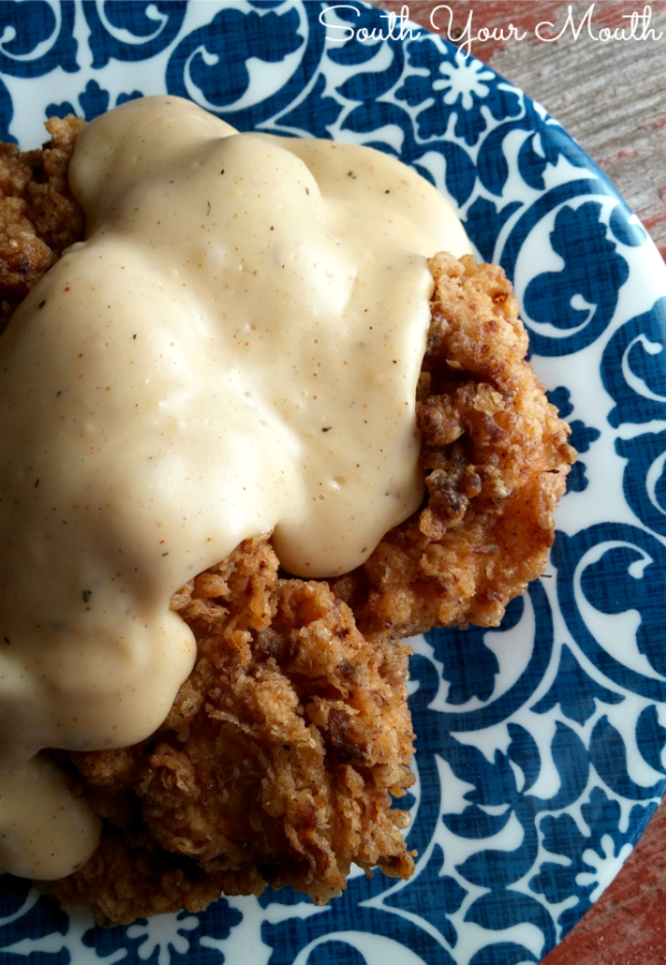 Country Fried Chicken with Gravy | A simple country fried chicken recipe with buttermilk marinated chicken breasts seasoned to perfection then fried until golden brown with homemade pan gravy perfect over mashed potatoes or rice.