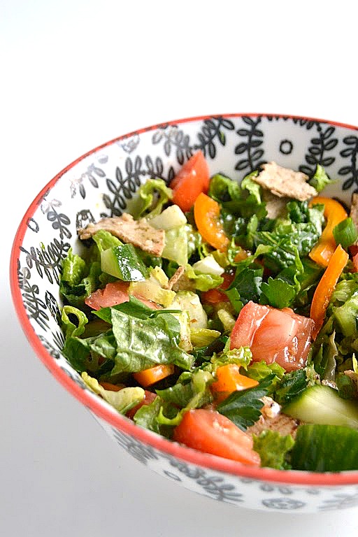 This Fattoush Salad recipe is a must try! An easy Middle Eastern chopped salad with loads of vegetables, a homemade lemon vinaigrette and toasted flatbread pieces. www.nutritionistreviews.com