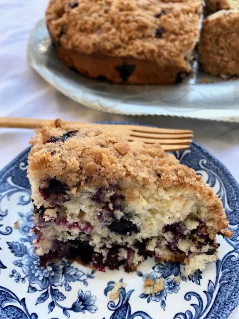 Side view of a slice of the blueberry buckle cake.