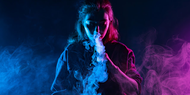 Picture of Women Doing Smoking Vape in Dark Room