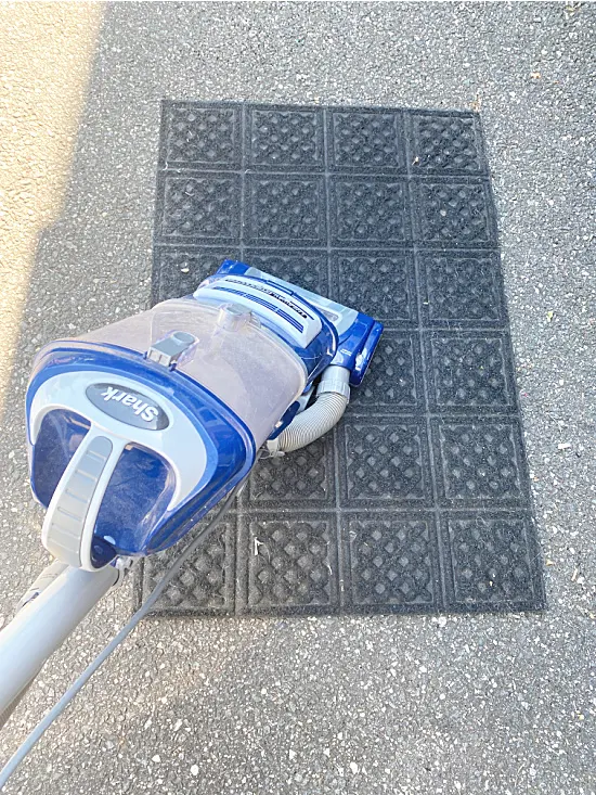 vacuuming the outdoor rug