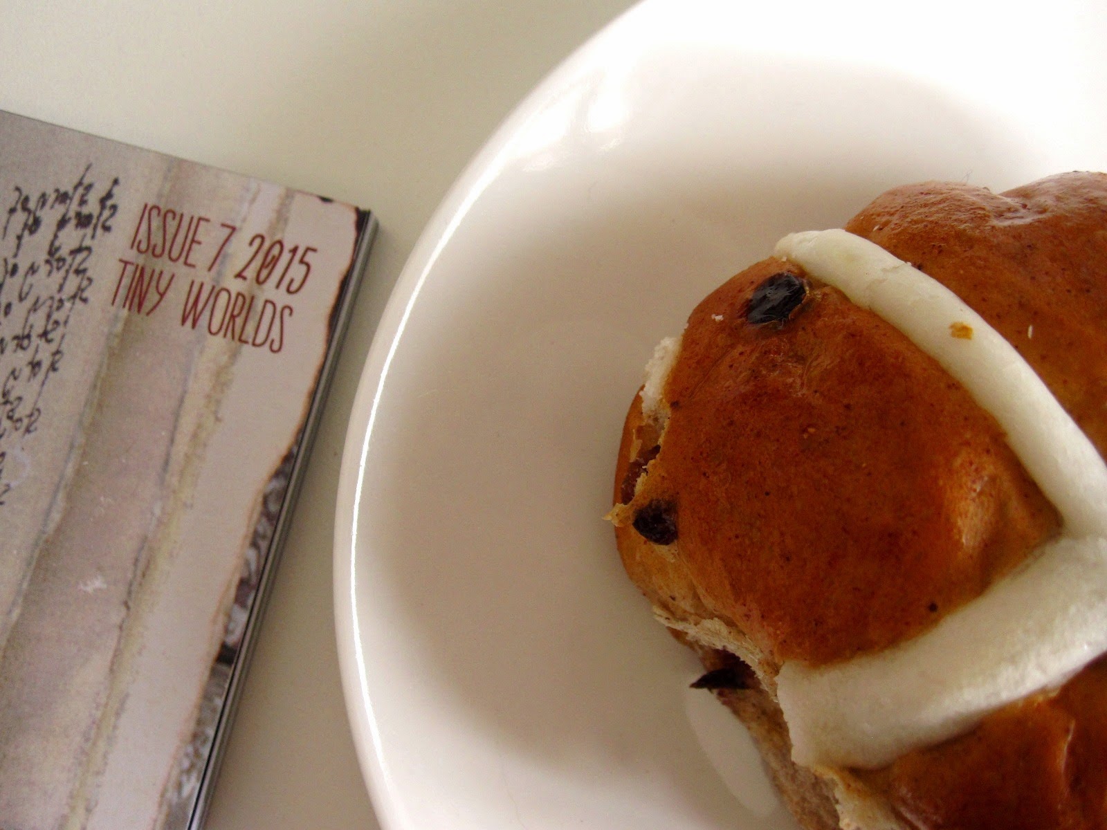 Magazine with 'Issue 7 205: Tiny worlds' written on the cover, next to a mini hot cross bun on a saucer.