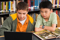 Two elementary boys reading