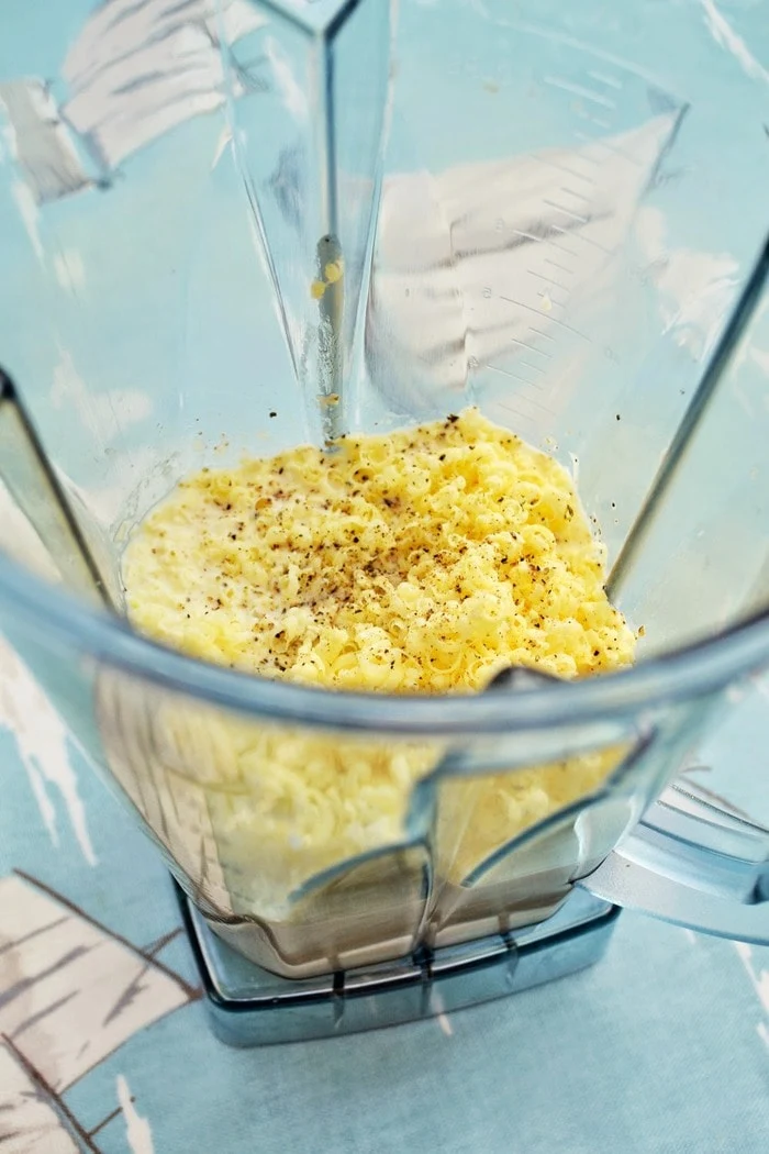 ingredients for cheese sauce in a blender jug