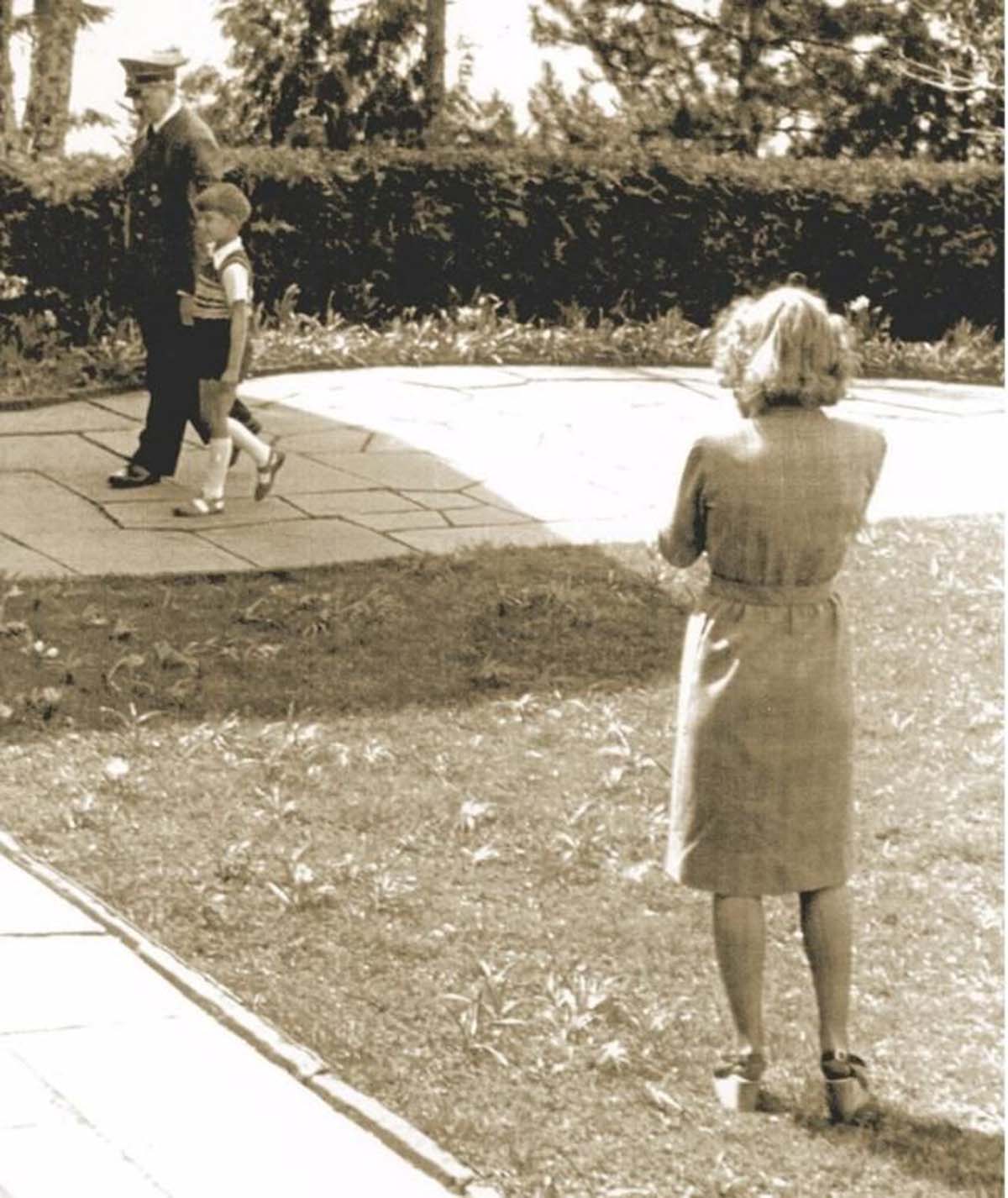 Eva's special talents as a photographer came in very handy for Hitler. Here she is taking one of the carefully posed propaganda photographs of Hitler with children that the government liked to distribute. It appears that she is wearing platform shoes, which did not hit peak fashionability for another few decades.