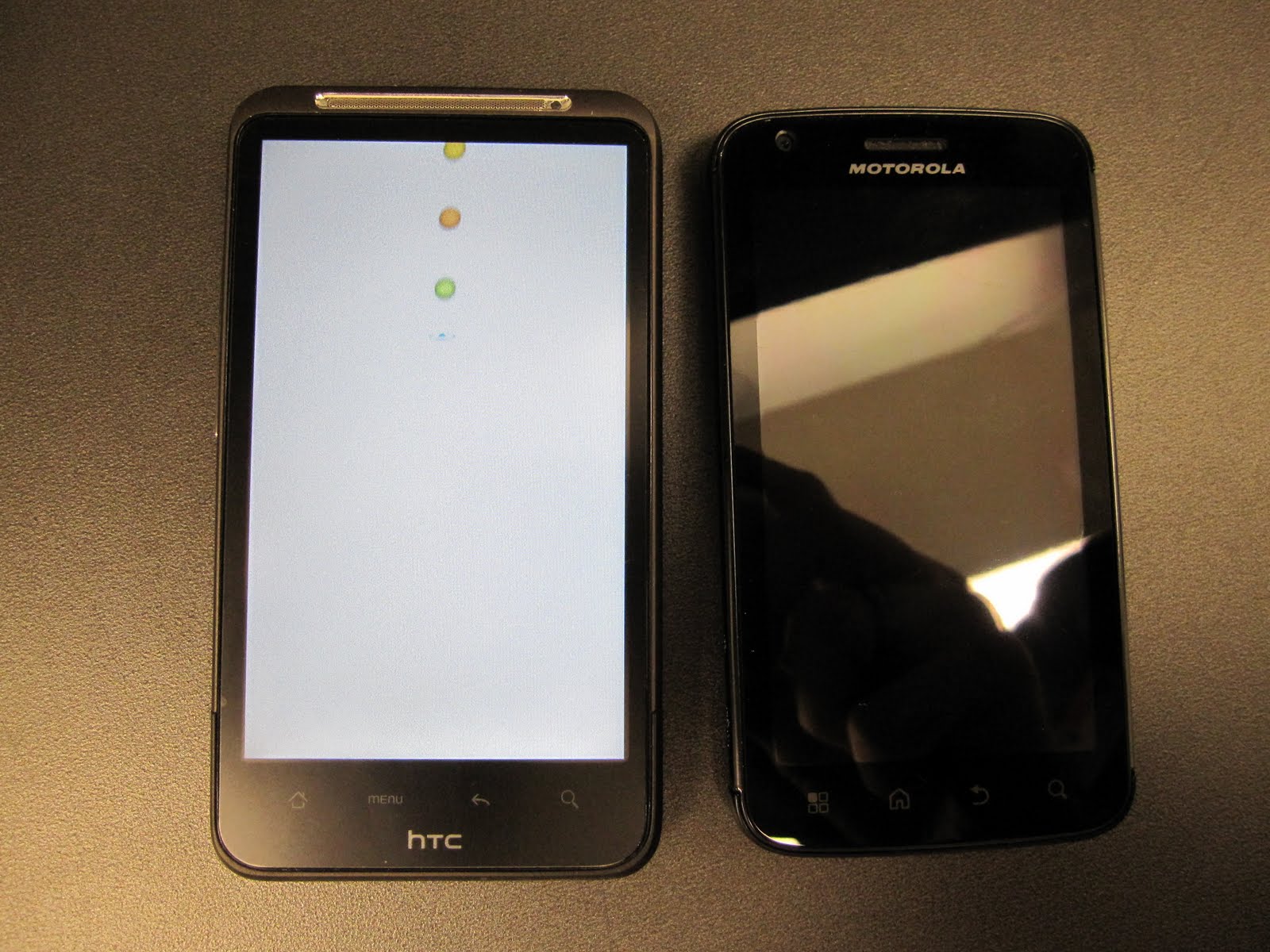 HTC Inspire next to the Motorola Atrix for size comparison.