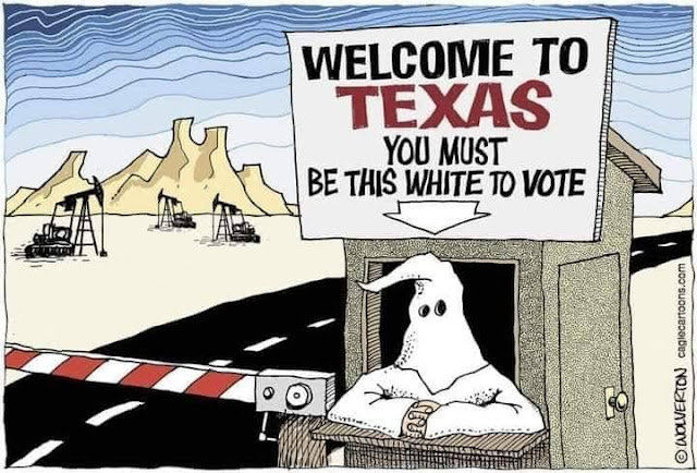 Border checkpoint for Texas.  A man wearing a KKK uniform sits in the booth beneath a sign pointing towards him and reading, 