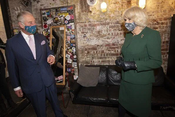 The Duchess of Cornwall wore a green skirt suit and black cape