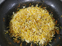 Placing rice over vegetables on a pan for restaurant style veg biryani recipe