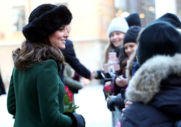 Kate Middleton wore a new bespoke Catherine Walker coat and dress. Duchess accessorised her coat with a faux fur collar and faux fur cuffs from Troy London