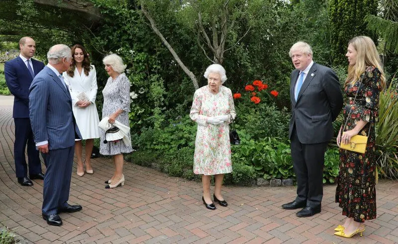 Queen in a floral outfit, Kate  in white coat dress, Carrie Johnson, wore a dressby Vampire’s Wife, Jill Biden in trench coat