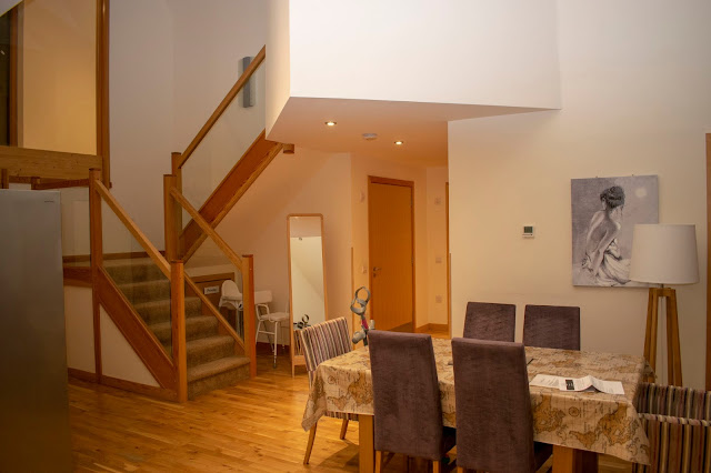 Dining area with stairs off to the side and a hallway