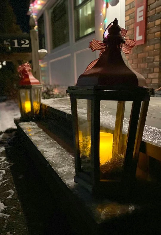 Christmas lanterns on a snowy stoop