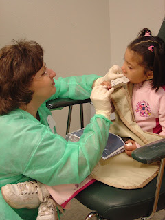 dental student examining child's teeth