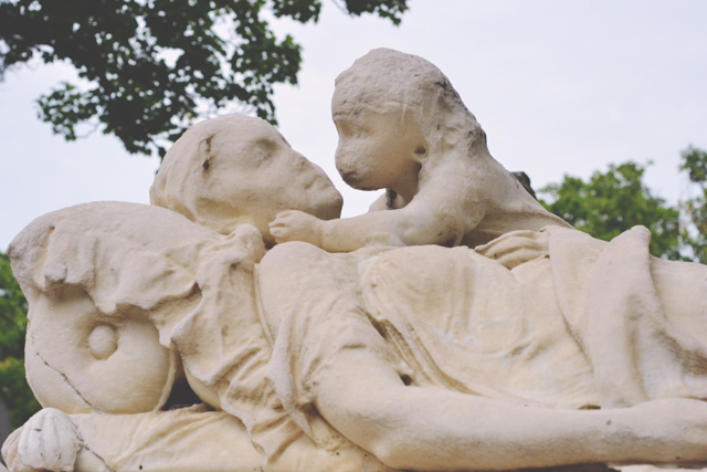 Weathered mother and child tombstone at Pere Lachaise Cemetery
