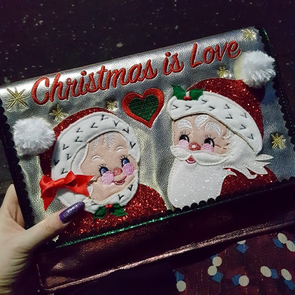 festive Christmas clutch on lap outside in dark on Christmas Eve