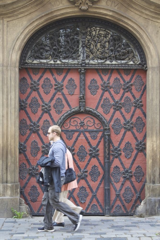 red door with passersby