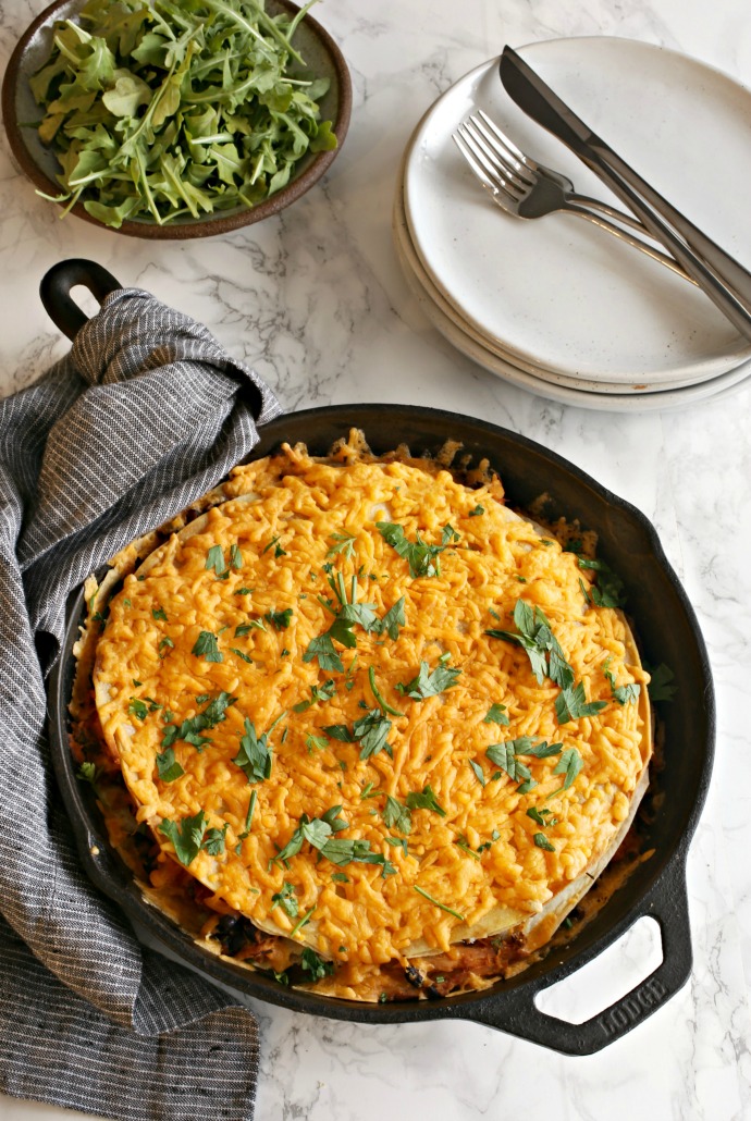 Recipe for a savory skillet pie filled with tortillas, shredded chicken, sauce and cheese.